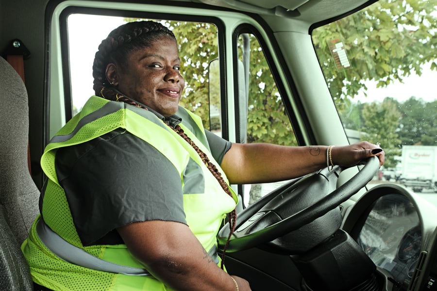 woman behind wheel of truck providing distribution services