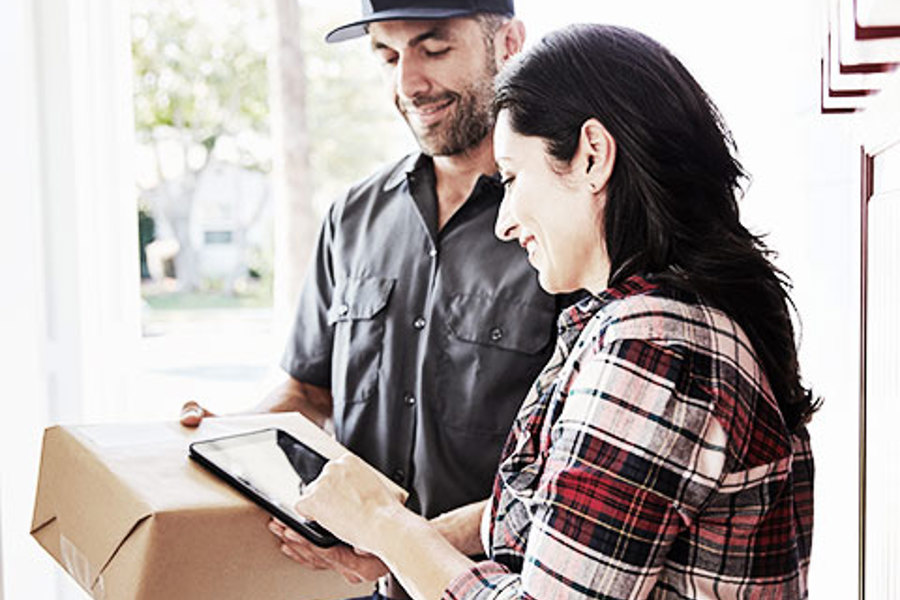 Customer receiving package from delivery driver