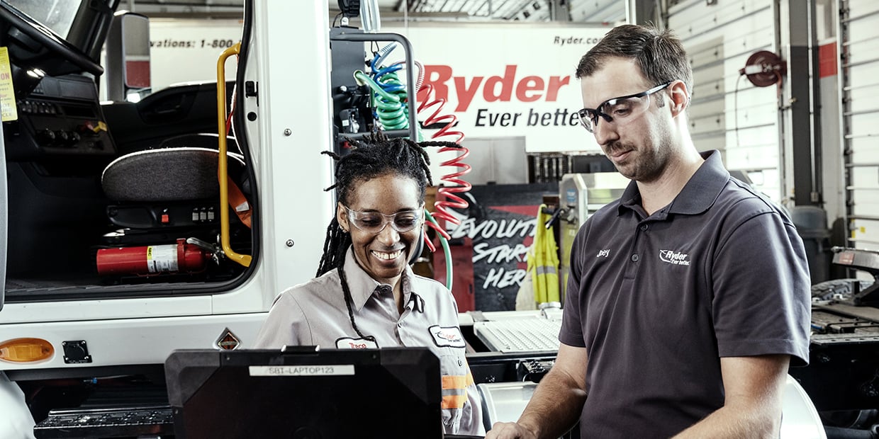 Two Ryder technicians servicing a leased semi truck Two Ryder technicians servicing a leased semi truck