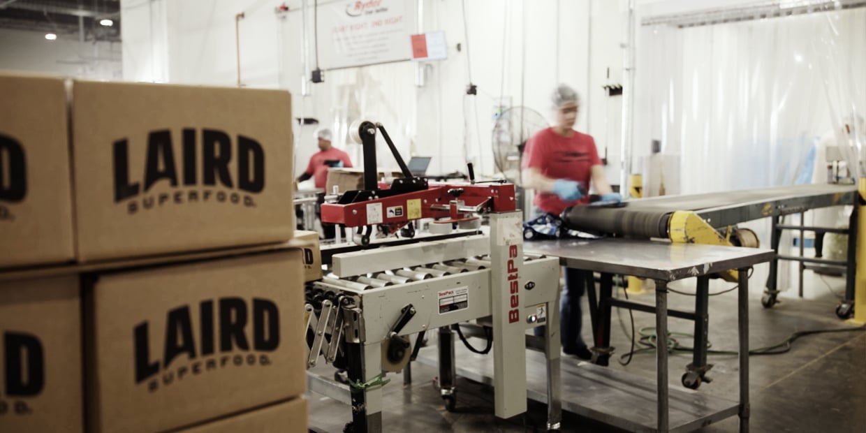 Ryder workers packing boxes on a contract packaging line in a co-packing facility Ryder workers packing boxes on a contract packaging line in a co-packing facility