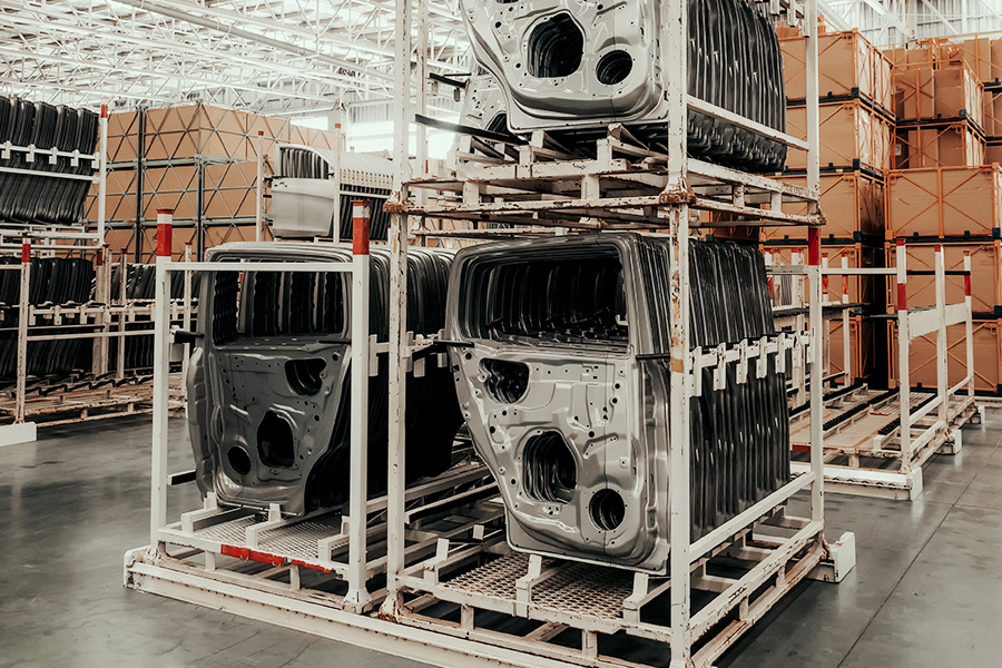 Rows of car doors being stored in a warehsouse