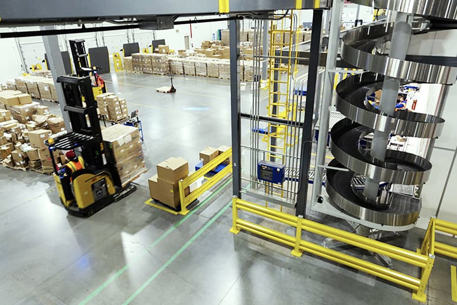 Warehouse filled with boxes, a converyer belt, and a forflift Warehouse filled with boxes, a converyer belt, and a forflift