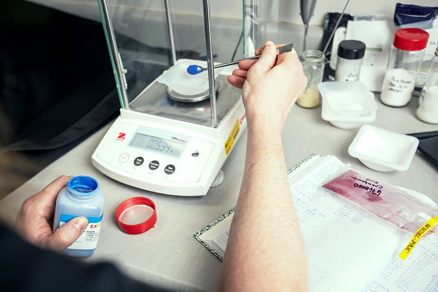 a scientist running tests in a lab a scientist running tests in a lab