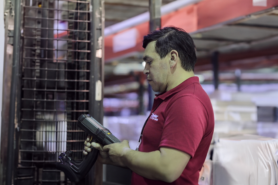employee at warehouse with hand held device