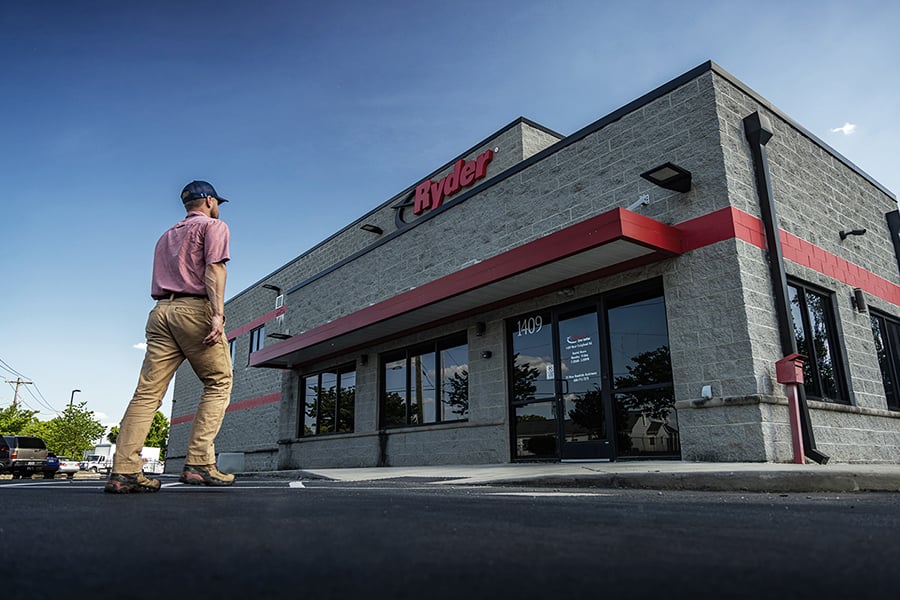 A Ryder employee walking into a Ryder rental location A Ryder employee walking into a Ryder rental location