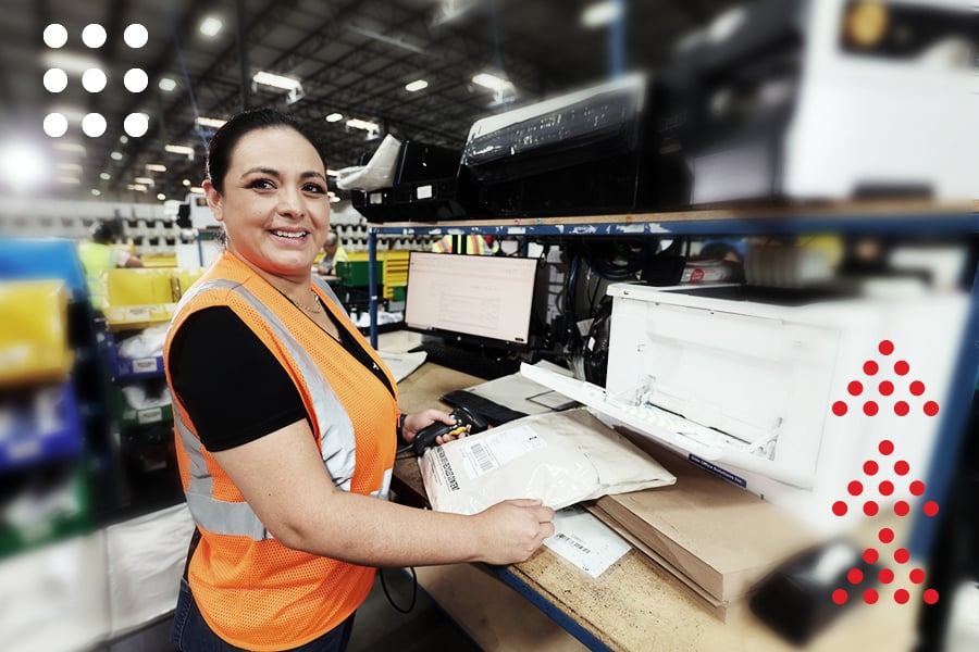 A ryder employee labeling packages at a fulfillment facility A ryder employee labeling packages at a fulfillment facility