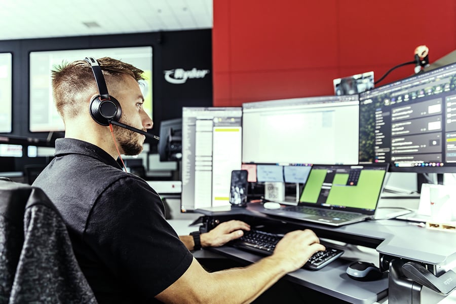 A Ryder transportation management employee working on a monitor A Ryder transportation management employee working on a monitor