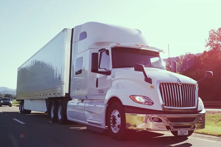 Video showcasing Ryder tandem axle sleeper tractor-trailer delivering goods Video showcasing Ryder tandem axle sleeper tractor-trailer delivering goods