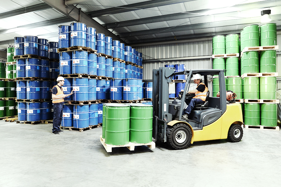 Forklift transporting chemicals in a warehouse Forklift transporting chemicals in a warehouse