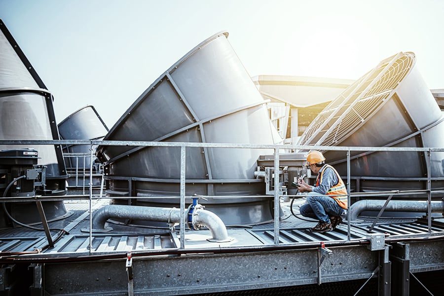 Engineer working on an industrial HVAC system Engineer working on an industrial HVAC system