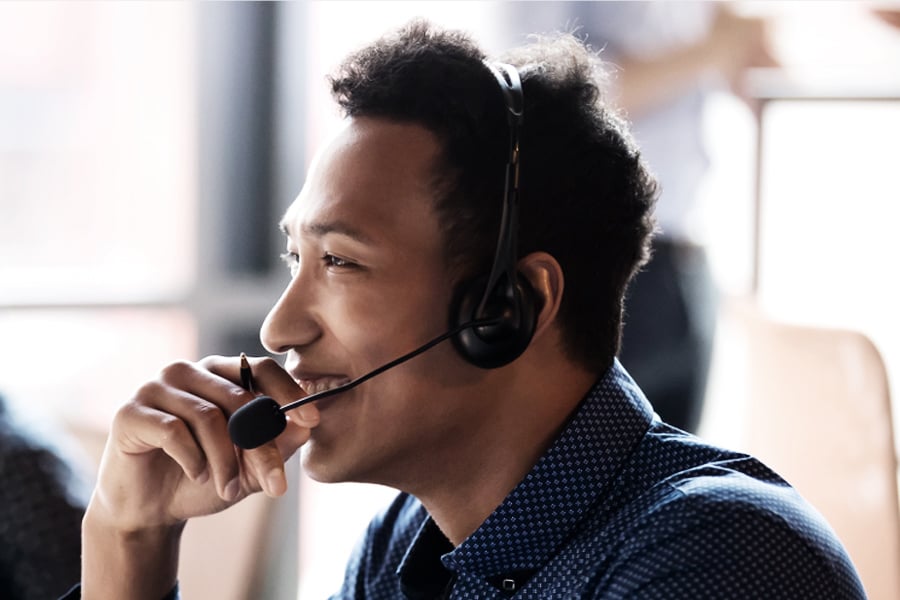 smiling customer support person for freight brokerage wearing phone headset